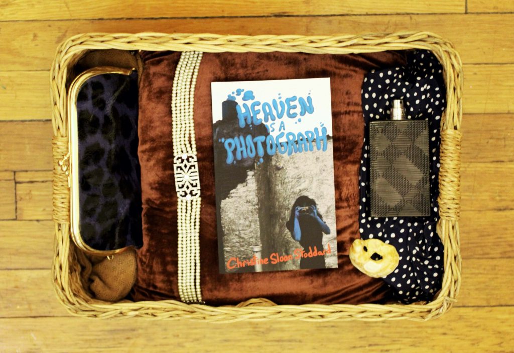 image of book, "Heaven is a Photograph" lying in a basket on brown velvet cloth
