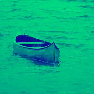 green-filtered image of empty canoe floating on water