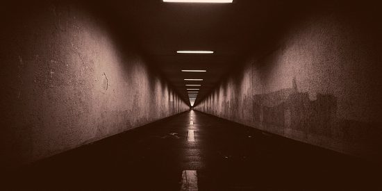 dark tunnel with light seeping in
