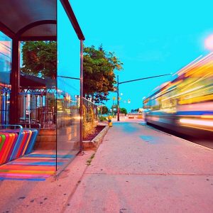 brightly colored transit center with blurred train passing by